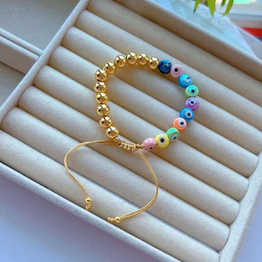 Pulsera Ajustable Combinada Ojitos y Perlas Doradas